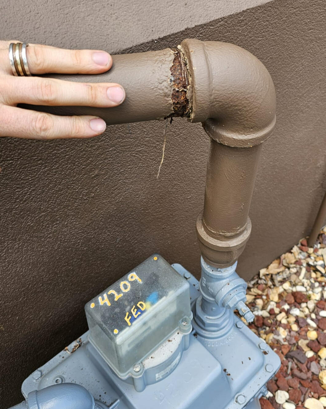 Expert Gas Leak Detection and Repairs A licensed gas installer fixes a gas leak from a faulty black iron pipe installation by a plumber, showcasing expert natural gas repair and maintenance. The photo highlights professional gas leak detection and repairs with gas-rated materials.